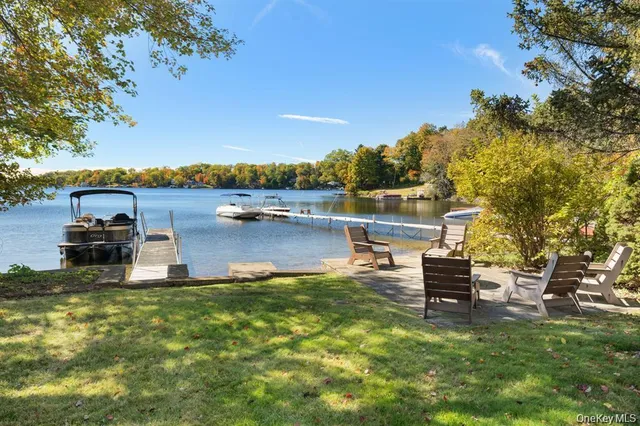 a view of a lake with table and chairs