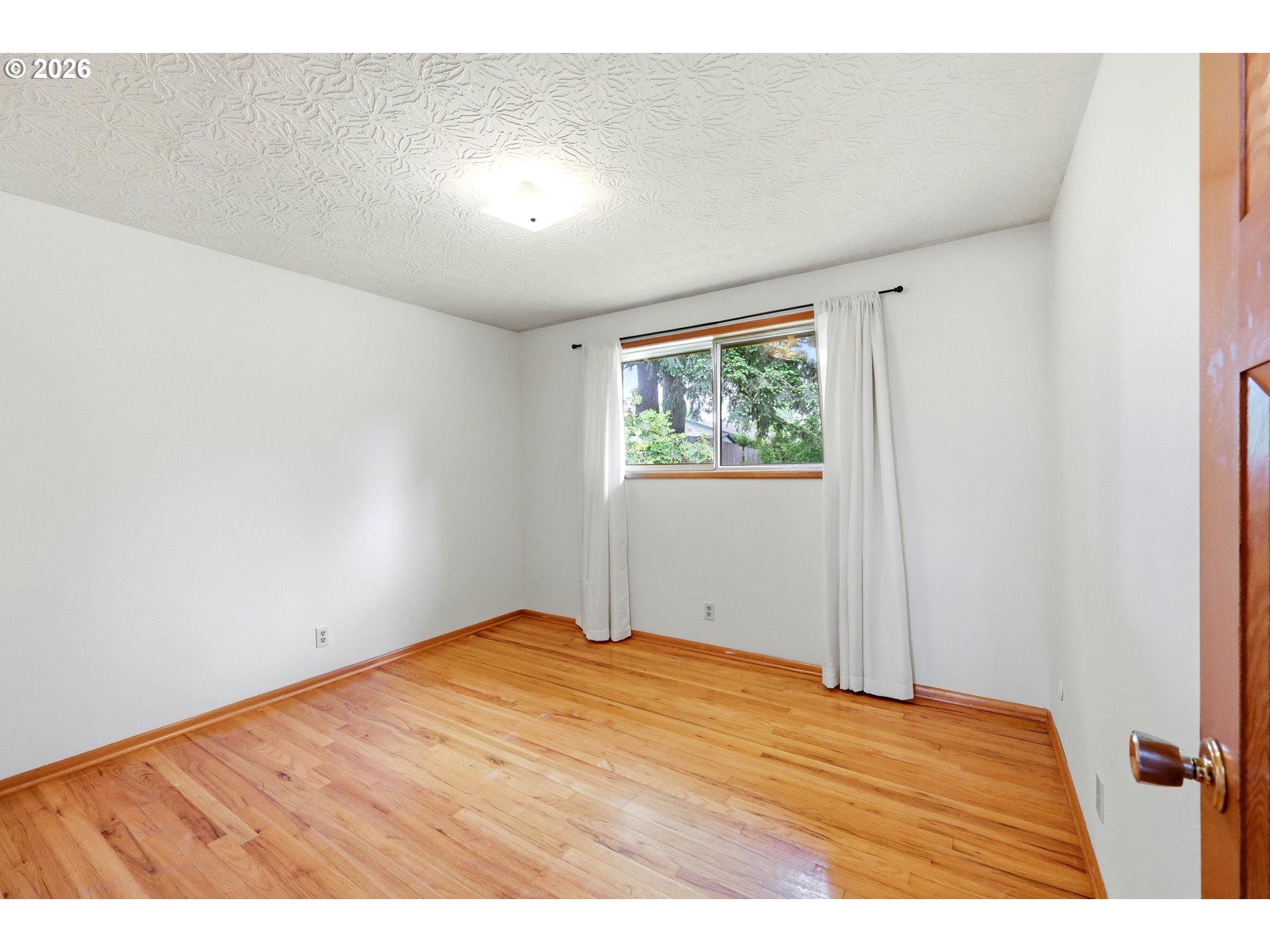 3003 Southeast 162nd Avenue Portland, OR 97236 - Photo 18 of 41 a bedroom with a bed and a window