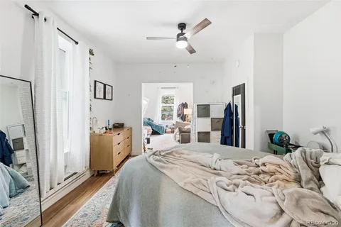 a bed room with a bed and a flat tv screen