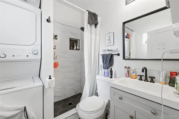 a bathroom with a sink toilet vanity and tub