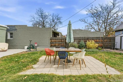 a view of a house with backyard sitting area and garden