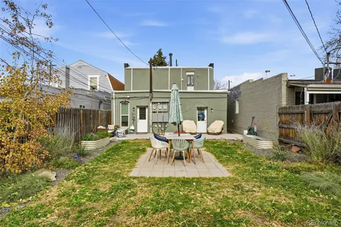 a backyard of a house with table and chairs