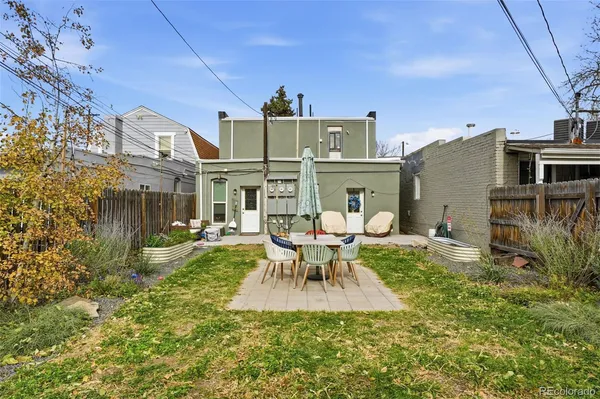 a backyard of a house with table and chairs