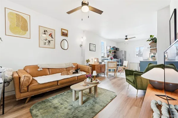 a living room with furniture a rug and wooden floor