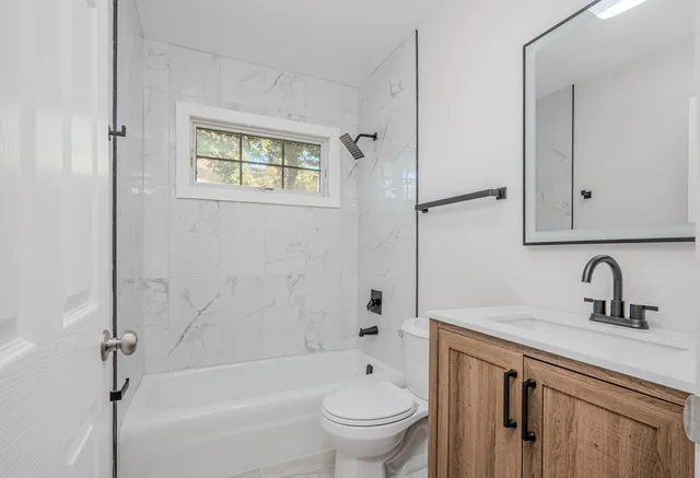 a bathroom with a sink a toilet and a bathtub