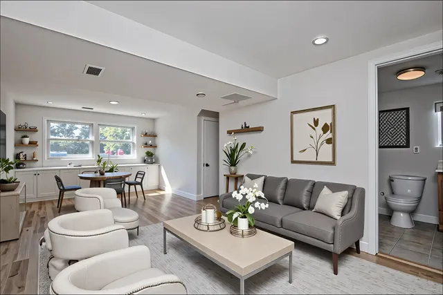 a living room with furniture and wooden floor