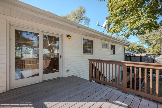 a view of a house with wooden deck front of house