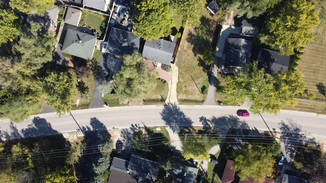 a view of a lake with boats and trees all around