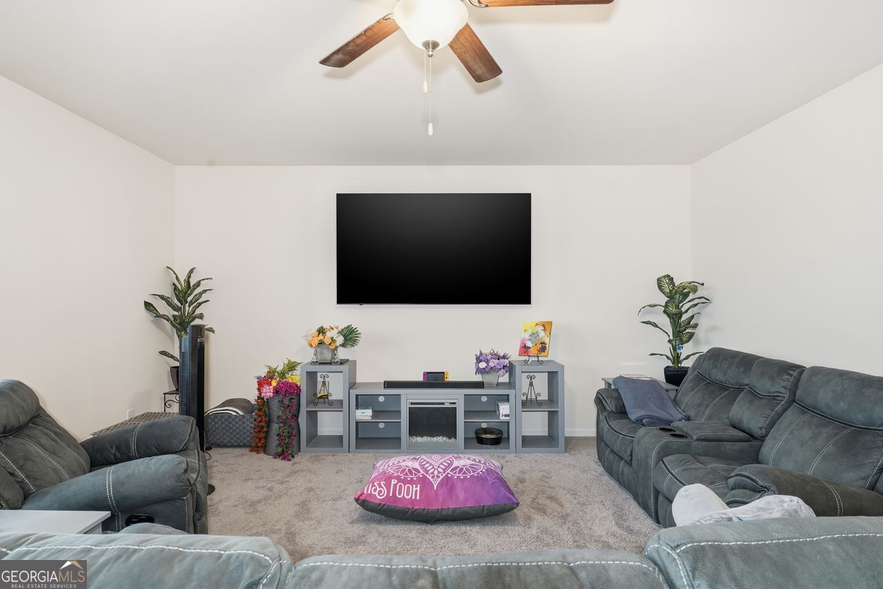 223 Malbone Street Southwest, Unit 5B Cartersville, GA 30120 - Photo 12 of 38 a living room with furniture and a flat screen tv