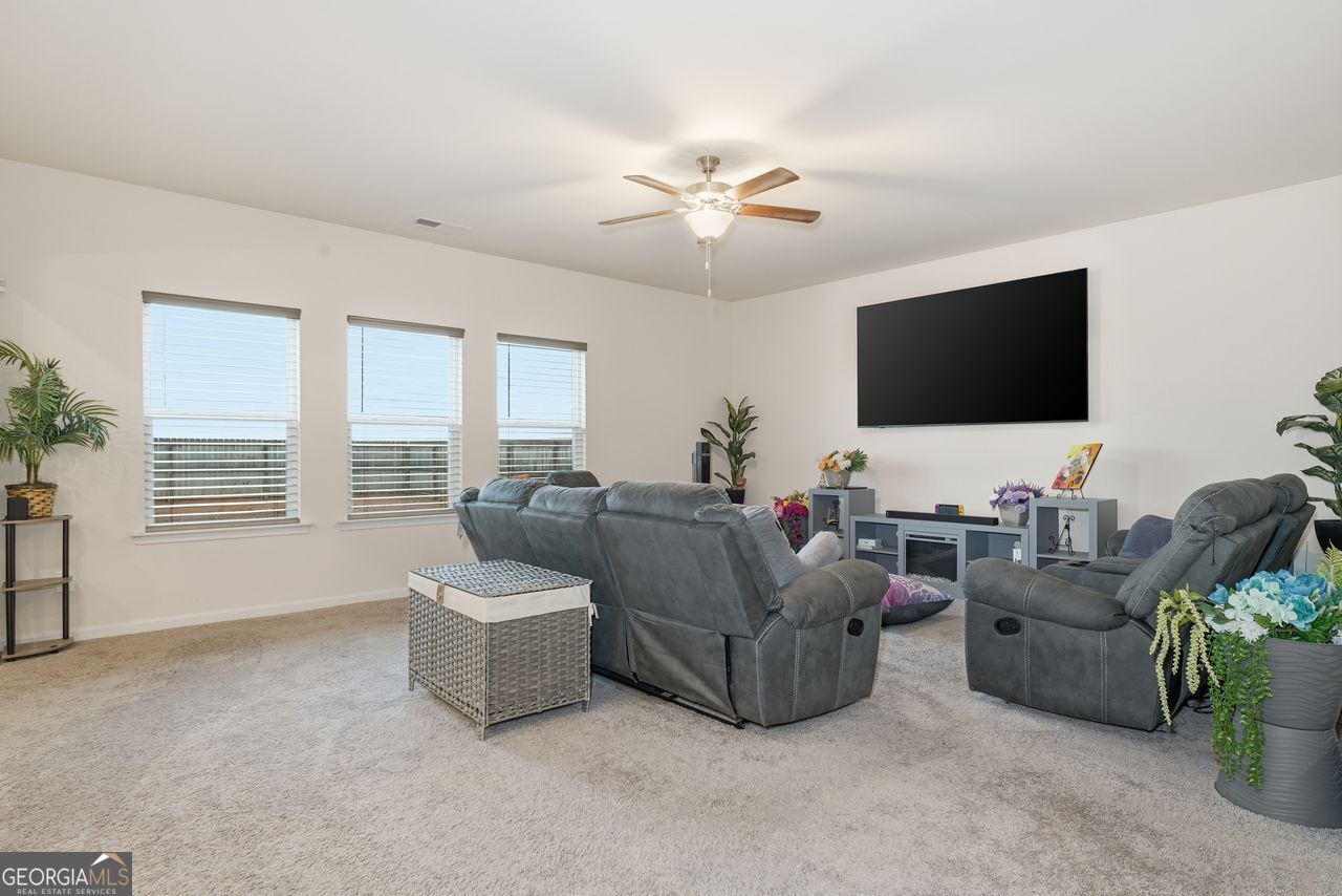 223 Malbone Street Southwest, Unit 5B Cartersville, GA 30120 - Photo 13 of 38 a living room with furniture and a flat screen tv