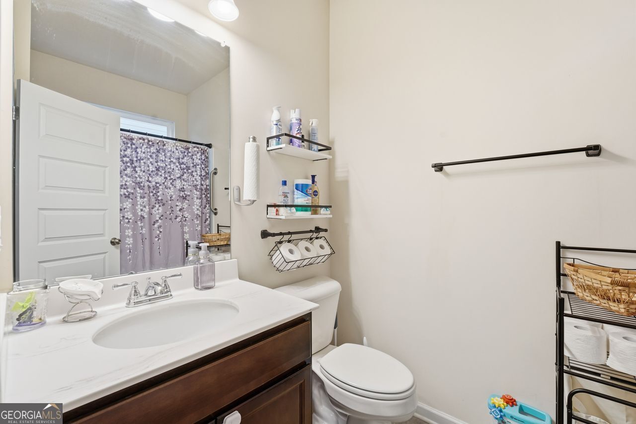 223 Malbone Street Southwest, Unit 5B Cartersville, GA 30120 - Photo 15 of 38 a bathroom with a sink a toilet a mirror and shower