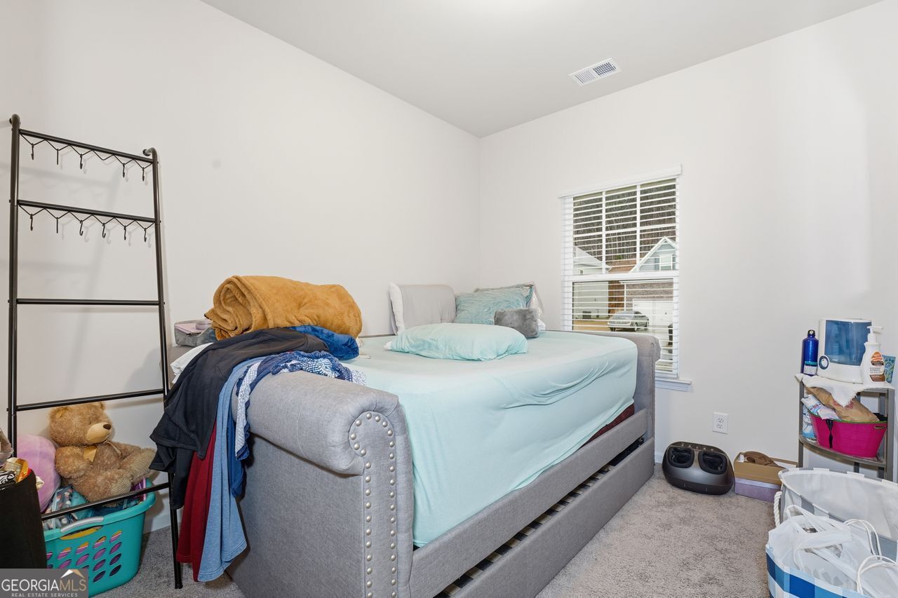 223 Malbone Street Southwest, Unit 5B Cartersville, GA 30120 - Photo 16 of 38 a bedroom with a bed and a window