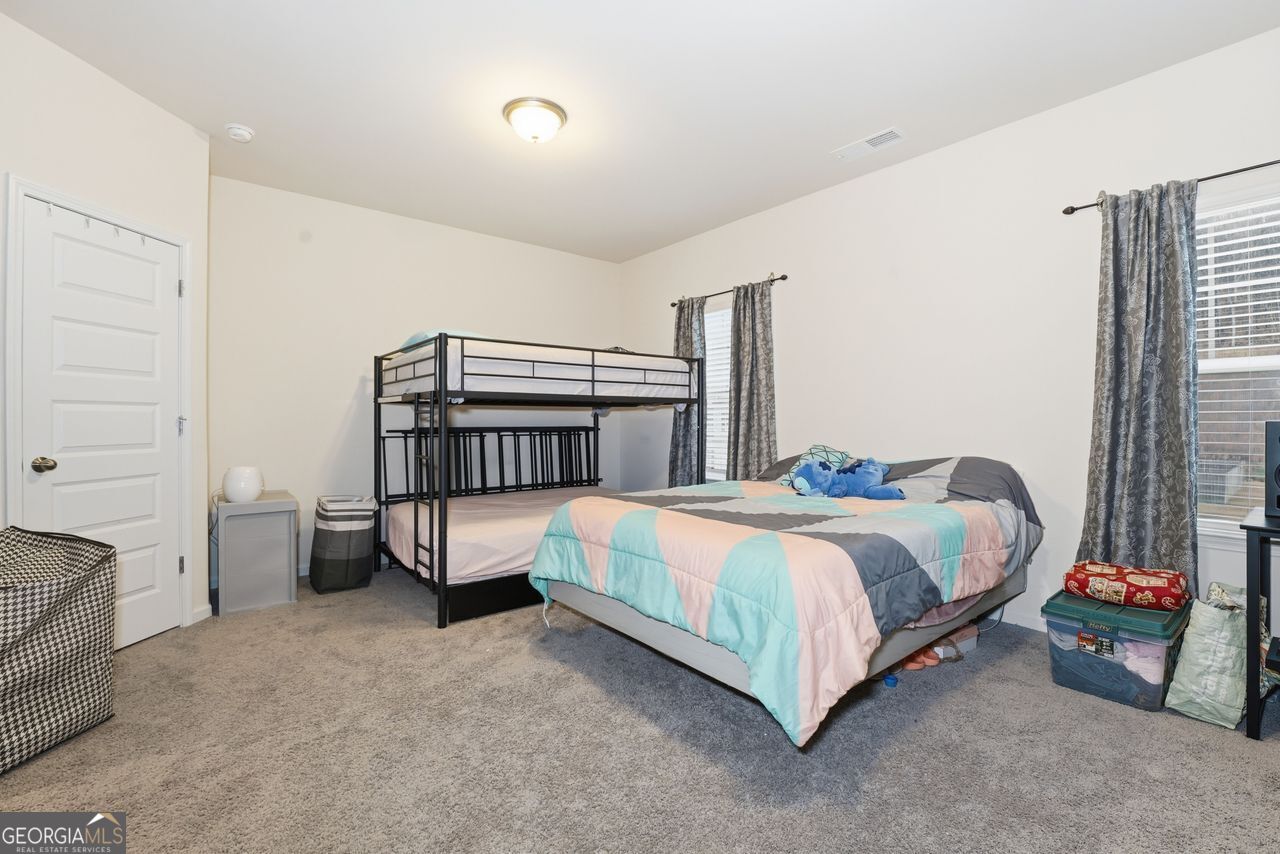 223 Malbone Street Southwest, Unit 5B Cartersville, GA 30120 - Photo 26 of 38 a bedroom with a bed and a window