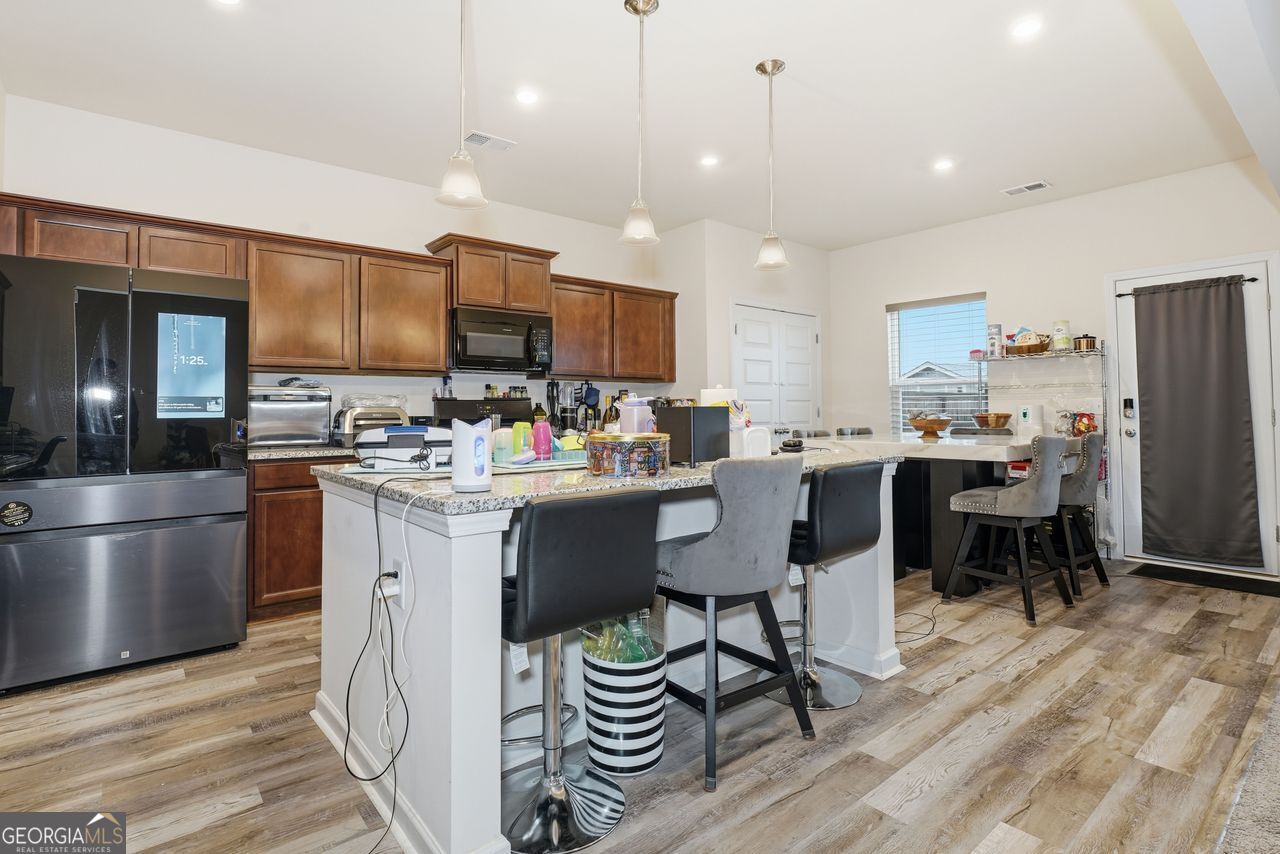 223 Malbone Street Southwest, Unit 5B Cartersville, GA 30120 - Photo 8 of 38 a kitchen with a sink appliances and cabinets