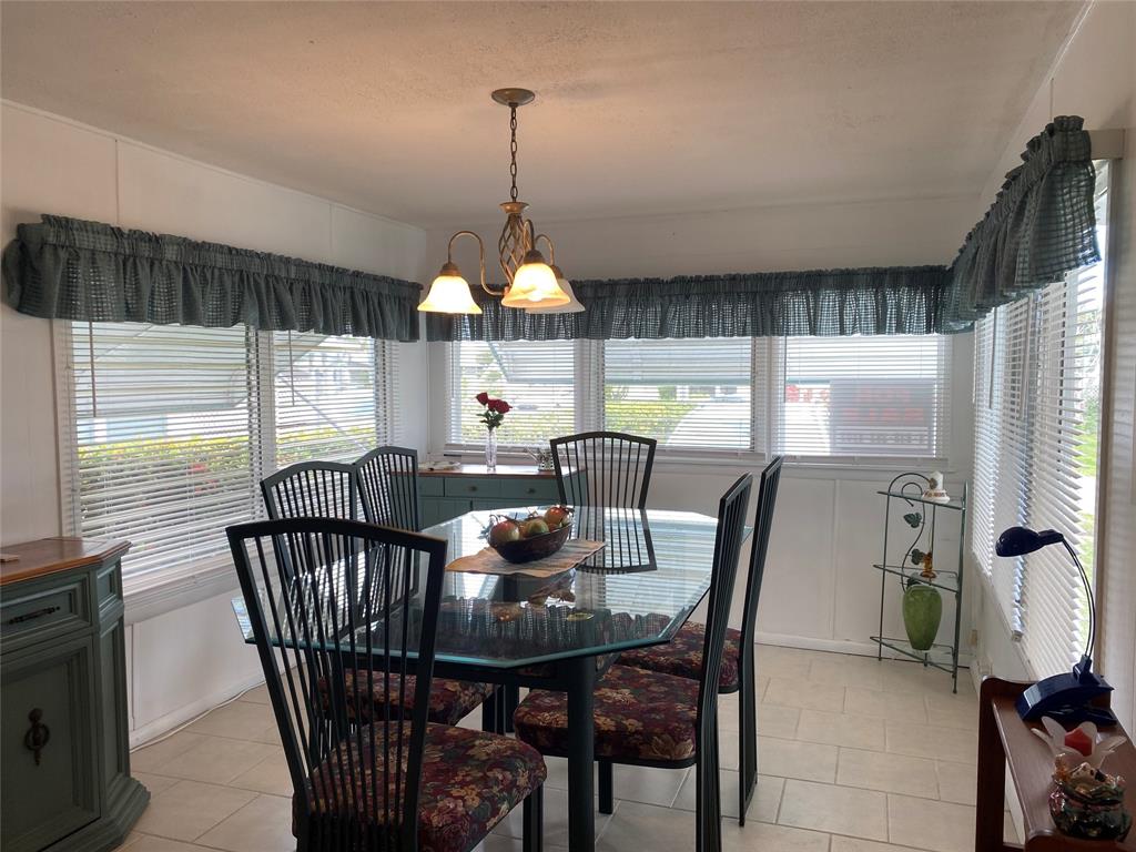 14629 Sunset Drive Delray Beach, FL 33445 - Photo 11 of 35 a view of a dining room with furniture window and outside view