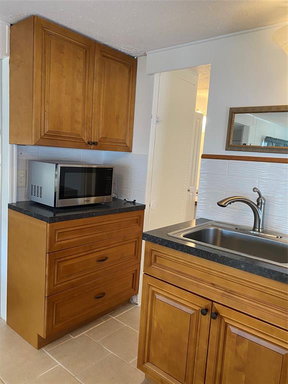 14629 Sunset Drive Delray Beach, FL 33445 - Photo 14 of 35 a view of kitchen with granite countertop cabinets and black appliances
