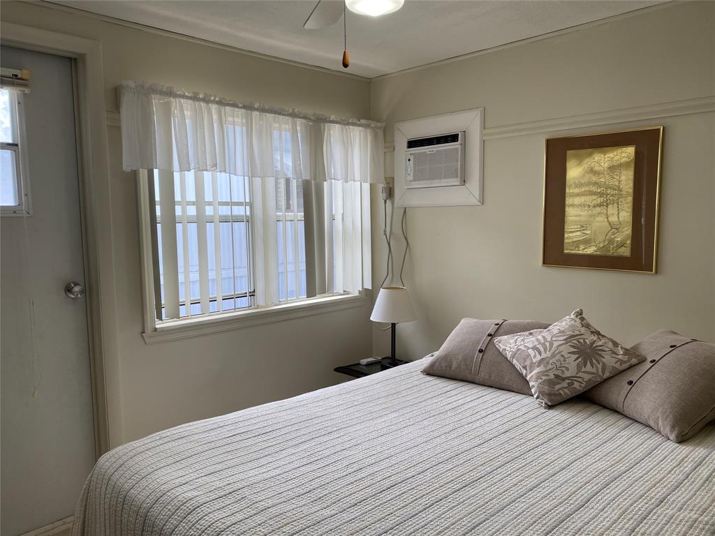 14629 Sunset Drive Delray Beach, FL 33445 - Photo 17 of 35 a bedroom with a bed and a window