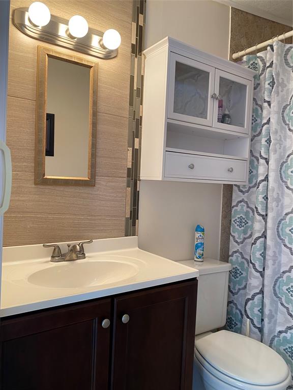 14629 Sunset Drive Delray Beach, FL 33445 - Photo 19 of 35 a bathroom with a sink a toilet and mirror