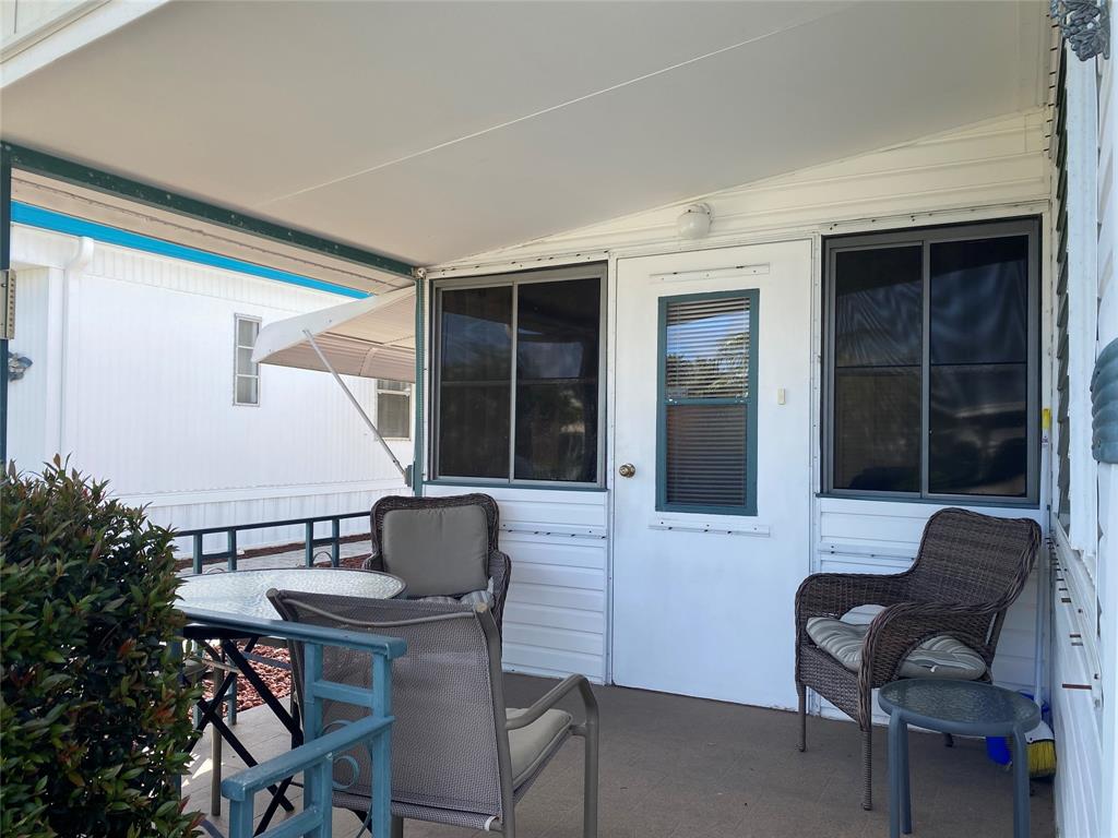 14629 Sunset Drive Delray Beach, FL 33445 - Photo 2 of 35 a patio with a table and chairs and potted plants