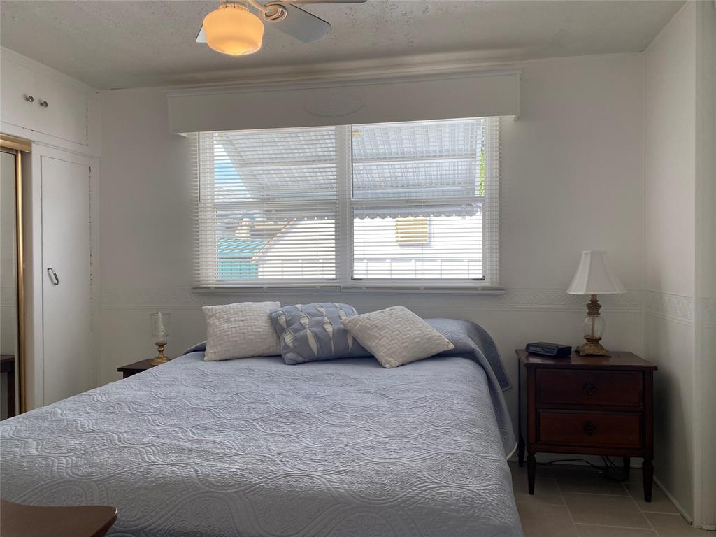 14629 Sunset Drive Delray Beach, FL 33445 - Photo 22 of 35 a bedroom with a bed and a window