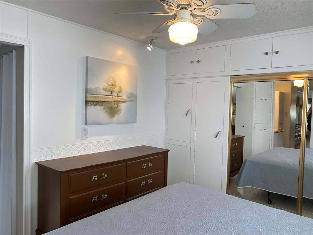 14629 Sunset Drive Delray Beach, FL 33445 - Photo 24 of 35 a bedroom with a bed and a mirror