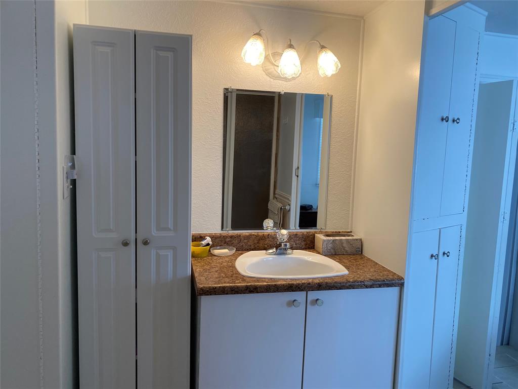 14629 Sunset Drive Delray Beach, FL 33445 - Photo 25 of 35 a bathroom with a sink and a mirror