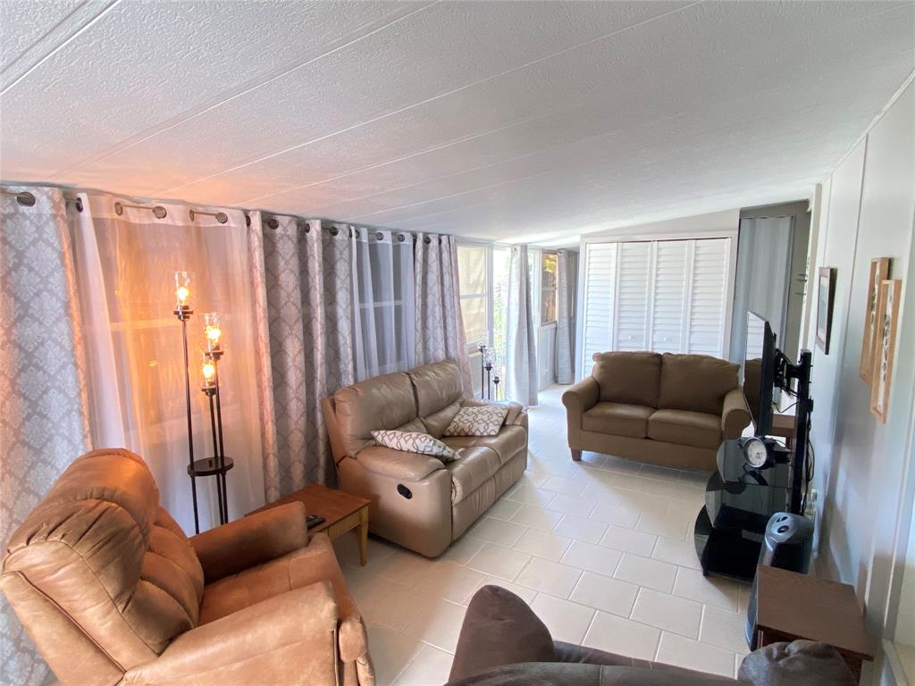 14629 Sunset Drive Delray Beach, FL 33445 - Photo 4 of 35 a living room with furniture and a large window