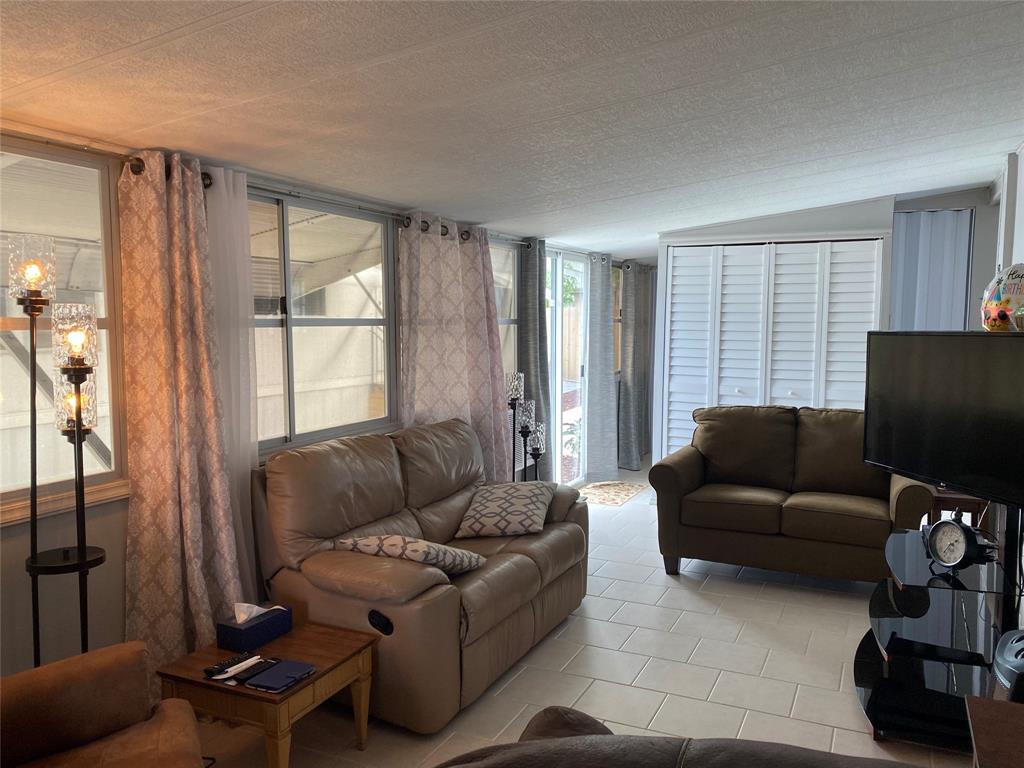 14629 Sunset Drive Delray Beach, FL 33445 - Photo 5 of 35 a living room with furniture and a flat screen tv