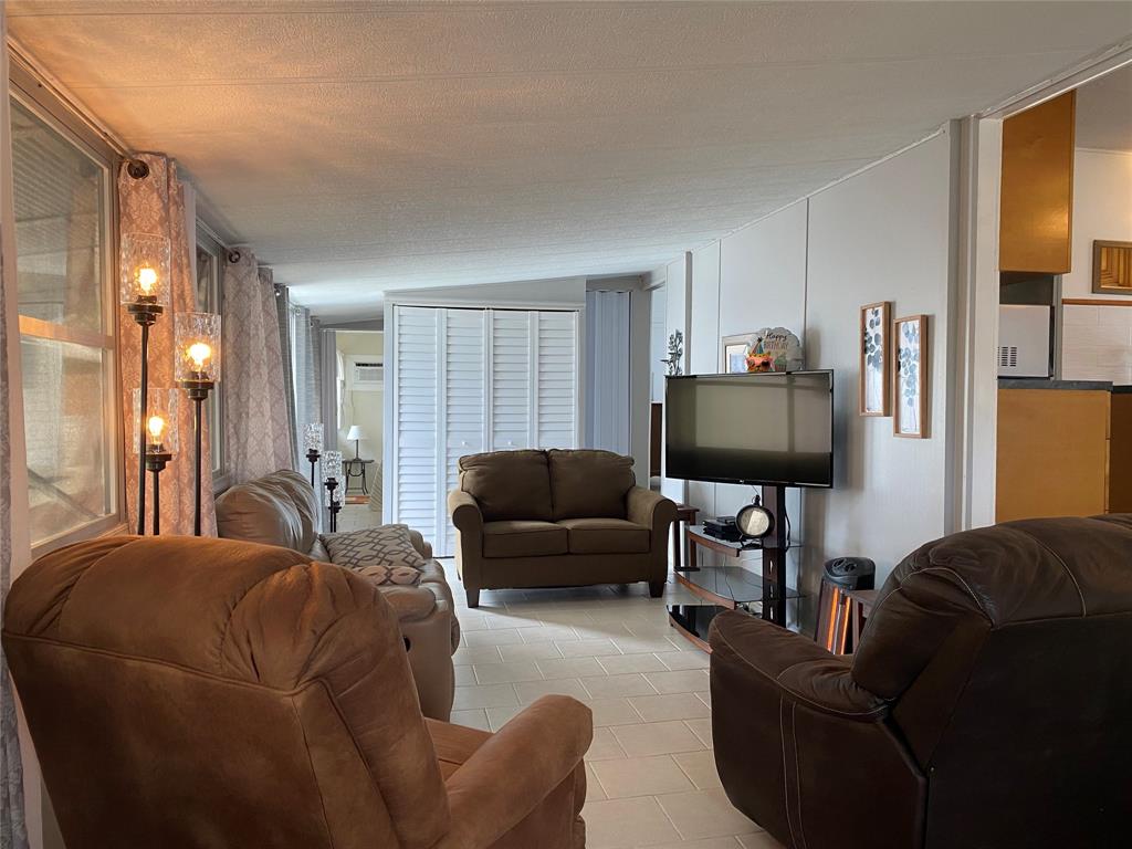 14629 Sunset Drive Delray Beach, FL 33445 - Photo 6 of 35 a living room with furniture and a flat screen tv