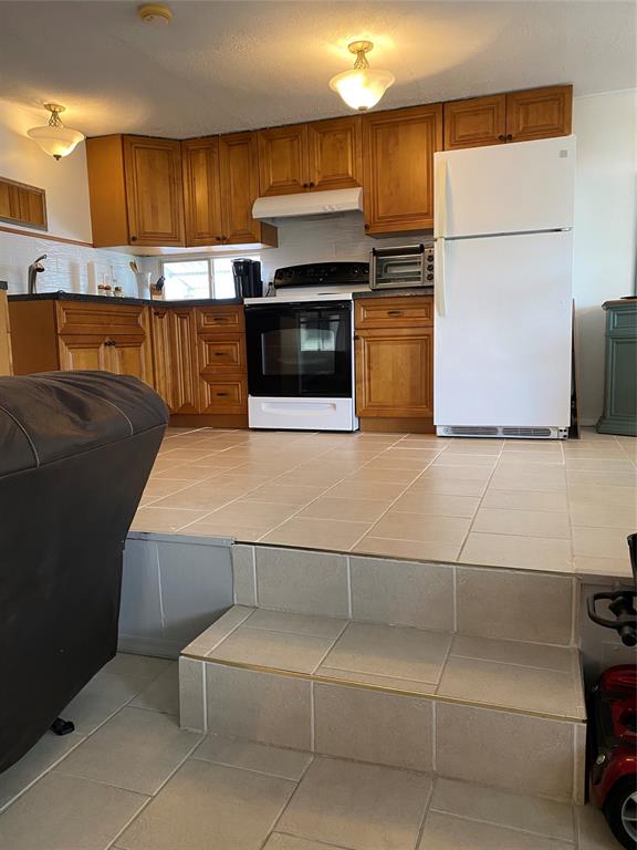 14629 Sunset Drive Delray Beach, FL 33445 - Photo 8 of 35 a kitchen with stainless steel appliances a refrigerator and a stove top oven