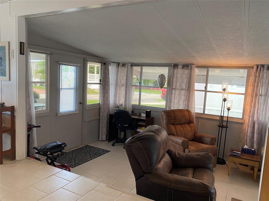 14629 Sunset Drive Delray Beach, FL 33445 - Photo 9 of 35 a living room with furniture and a floor to ceiling window