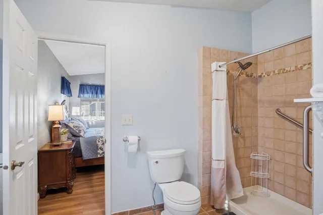 a bathroom with a toilet and a shower