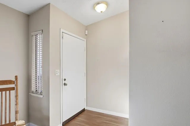 a view of a hallway with wooden floor