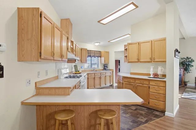 a large kitchen with cabinets table and chairs