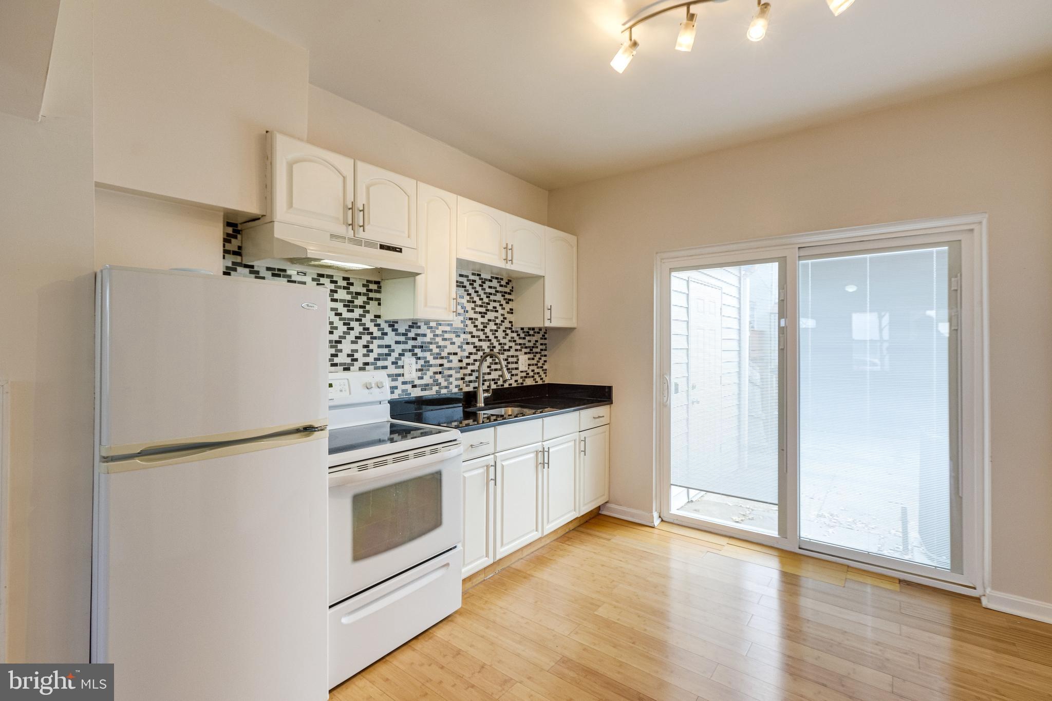 1119 3rd Street Northeast Washington, DC 20002 - Photo 11 of 31 a kitchen with stainless steel appliances granite countertop a refrigerator and a stove