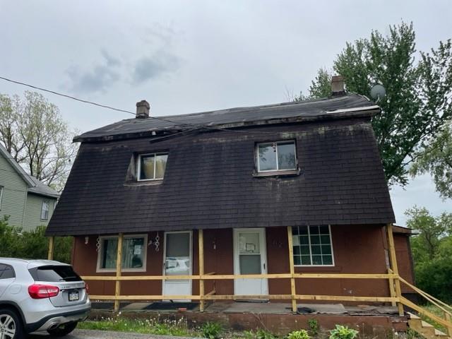 82-84 Roundtop Road Irwin, PA 15642 - Photo 1 of 11 a front view of a house with a garden