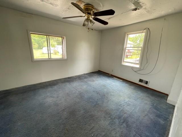 82-84 Roundtop Road Irwin, PA 15642 - Photo 6 of 11 a view of a livingroom with a ceiling fan and window