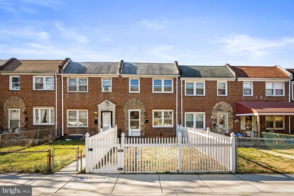 a front view of a residential apartment building with a yard