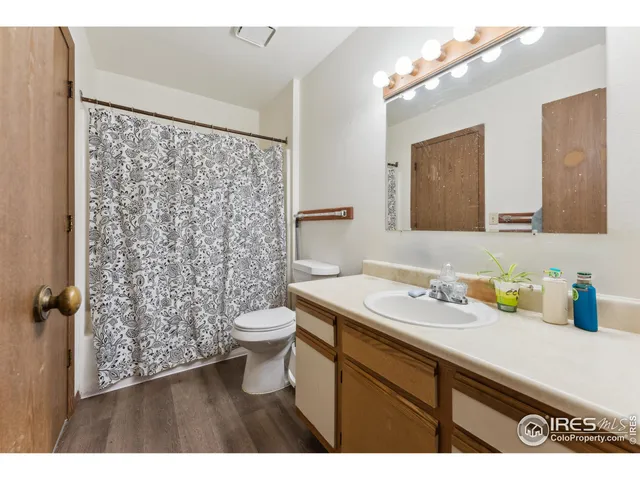 a bathroom with a sink a toilet a shower and a mirror