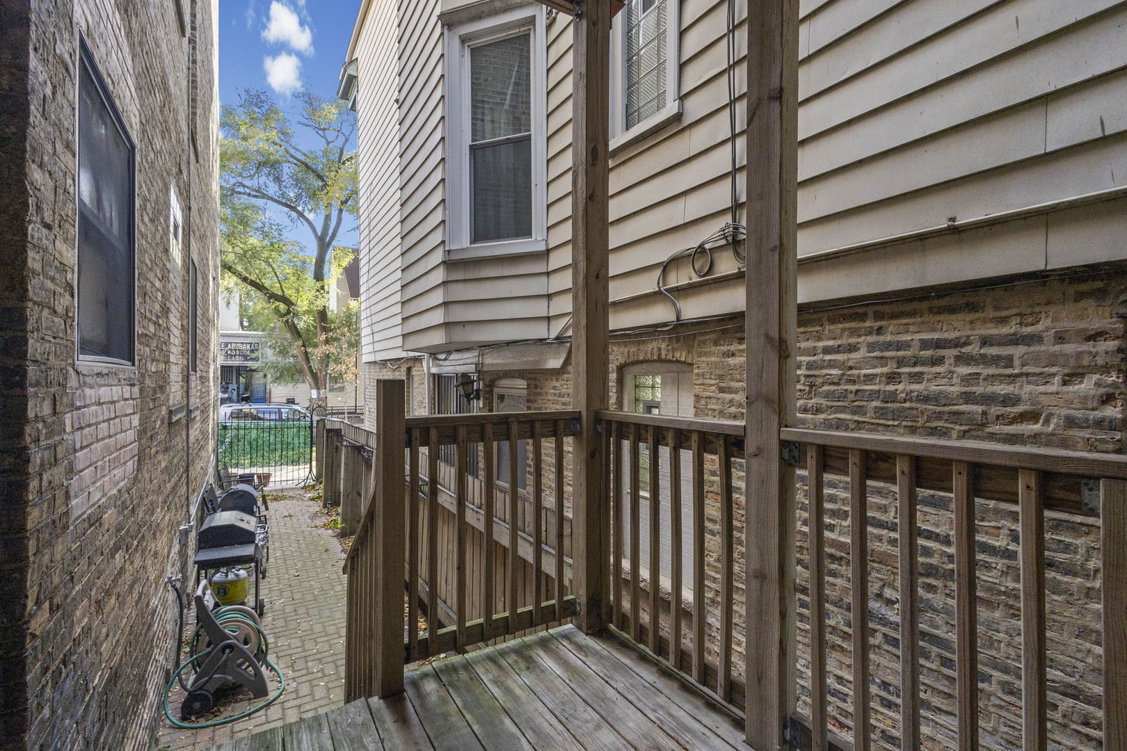 1014 West Roscoe Street, Unit 1F Chicago, IL 60657 - Photo 15 of 15 a view of a balcony with wooden floor and fence