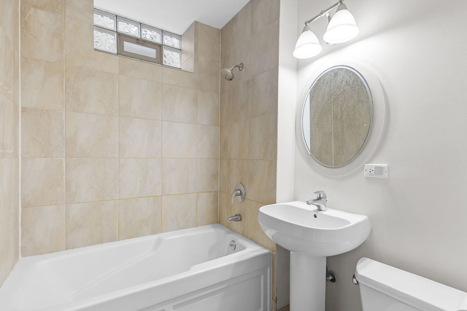 1014 West Roscoe Street, Unit 1F Chicago, IL 60657 - Photo 8 of 15 a bathroom with a sink and a mirror