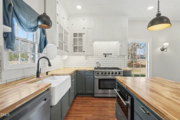 a kitchen with stainless steel appliances granite countertop a stove and a sink