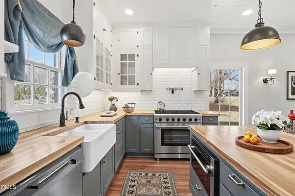 a kitchen with stainless steel appliances granite countertop a stove and a sink