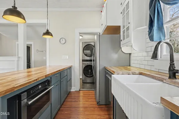 a kitchen with stainless steel appliances granite countertop a sink and a stove