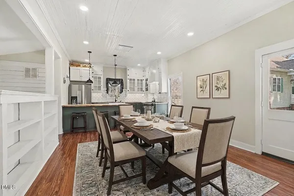 a dining room with kitchen island a table and chairs
