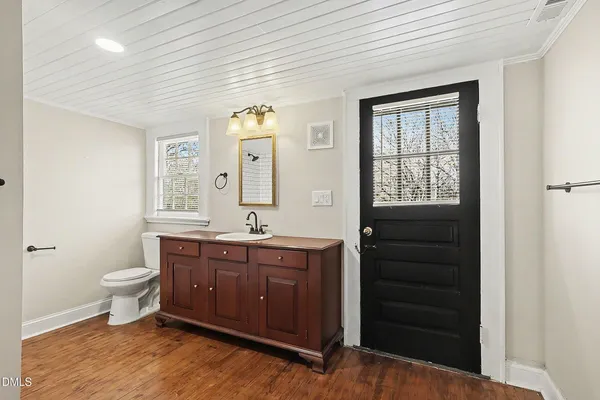 a spacious bathroom with a double vanity sink a toilet and a window