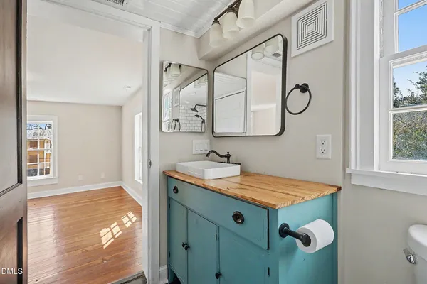 a bathroom with a sink and mirror