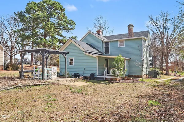 a view of a house with a yard covered in snow