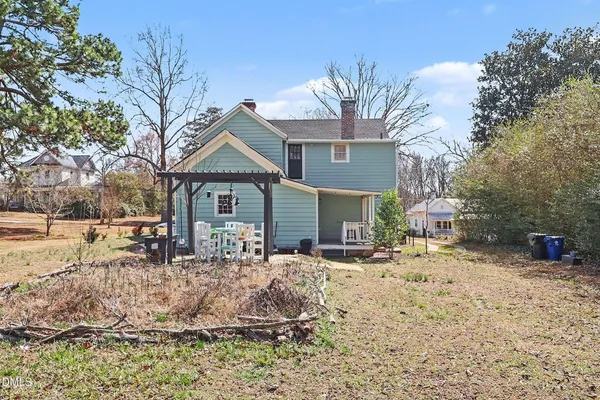 a front view of a house with a yard covered in snow