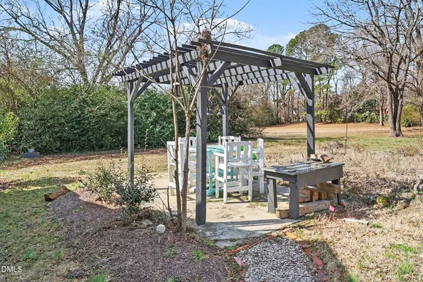 a view of a bench in the patio next to a yard